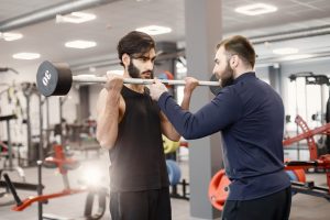 a client doing exercises with  a trainer