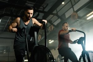 two men working out on a cycling machine